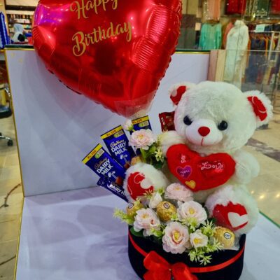 Beautiful birthday gift arrangement featuring a cute teddy bear