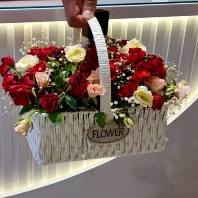 Beautiful flower basket filled with vibrant red, white, and soft Rose flower